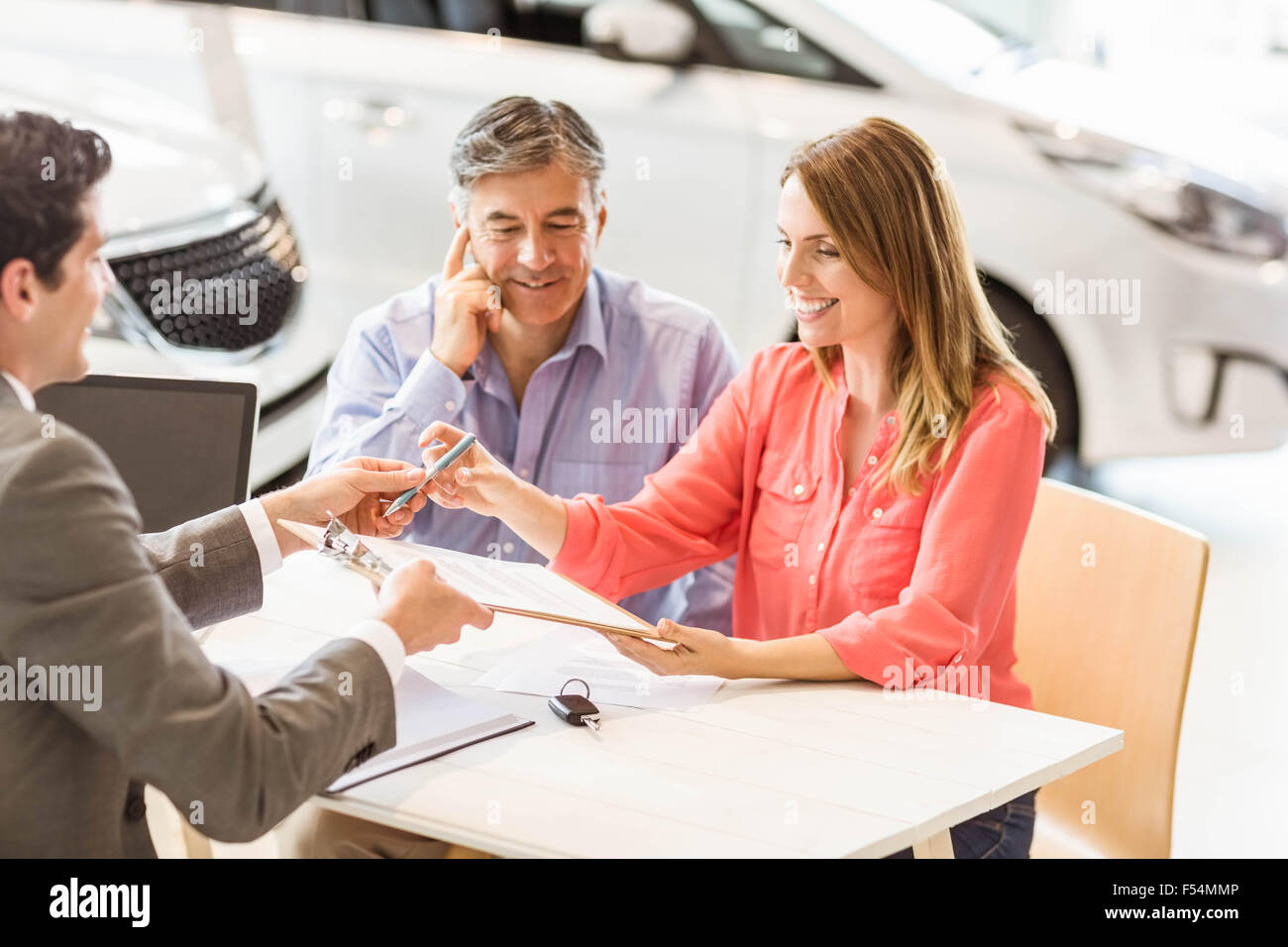 Smiling couple buying a new car Stock Photo