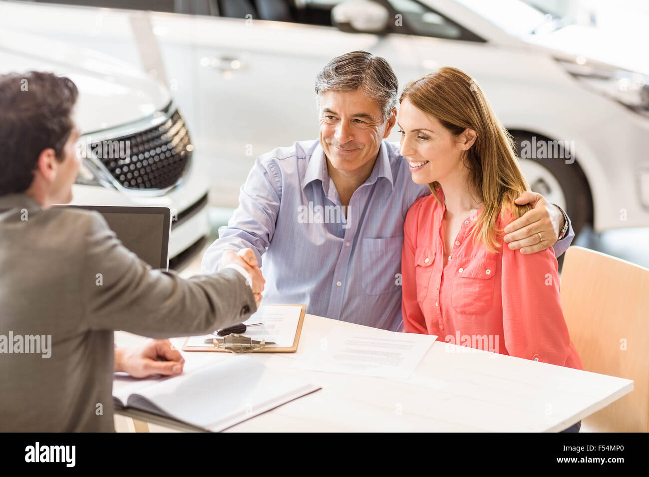 Smiling couple buying a new car Stock Photo