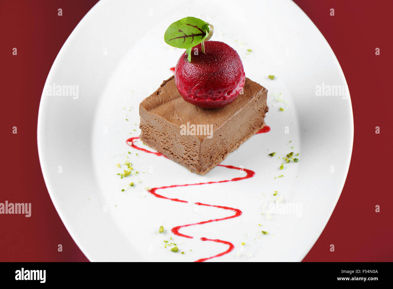 Gourmet chocolate mouse ice cream dessert with a dark cherry sorbet. Stock Photo