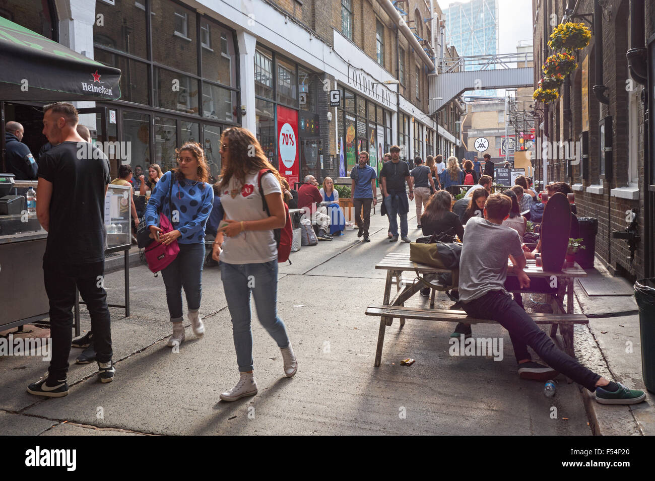 Young people drinking and eating in Shoreditch, London England United Kingdom UK Stock Photo
