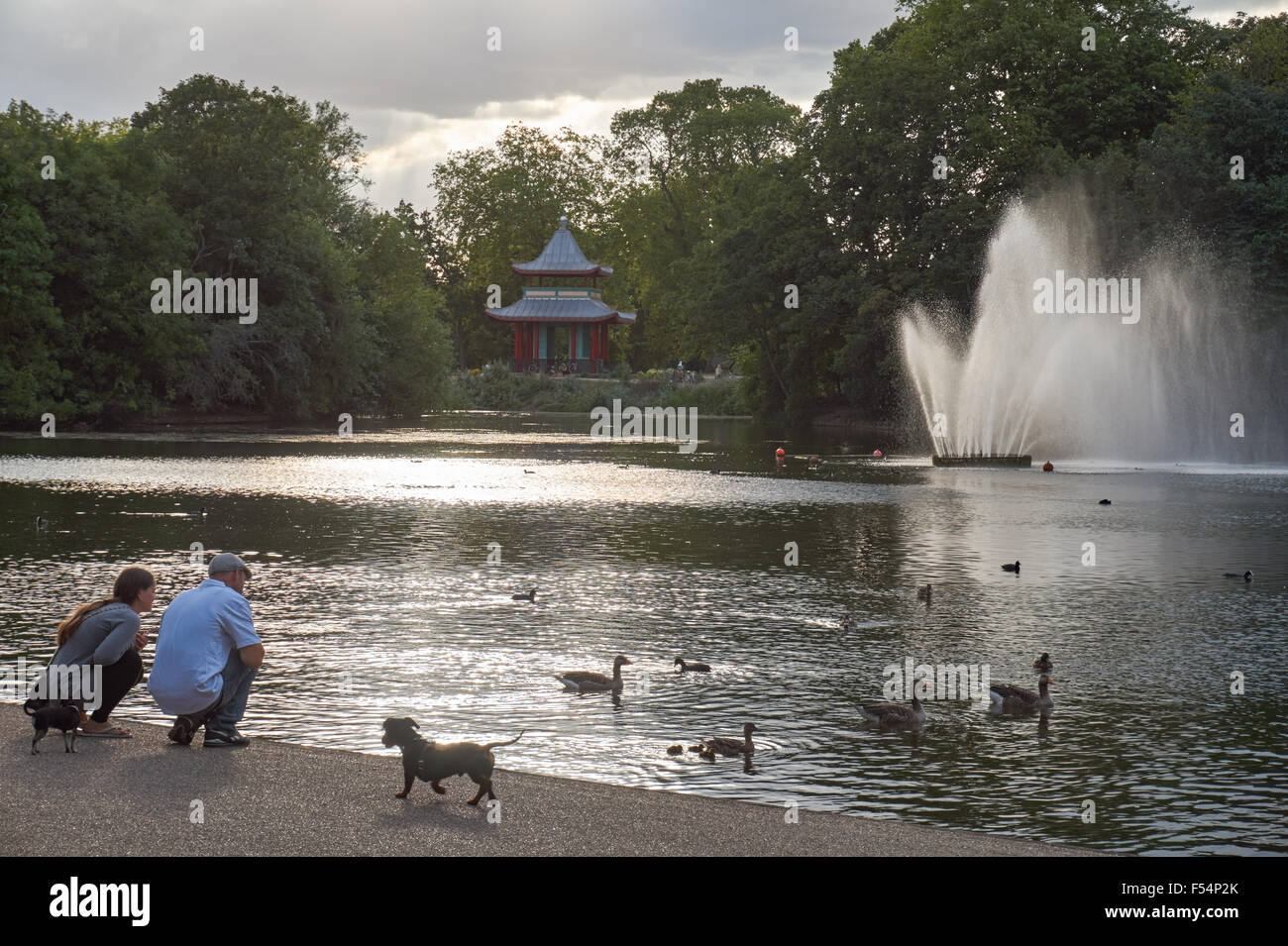 Londoners enjoying warm afternoon in Victoria Park, London England United Kingdom UK Stock Photo