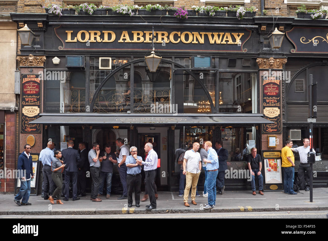 People drinking outside The Lord Aberconway pub in London England