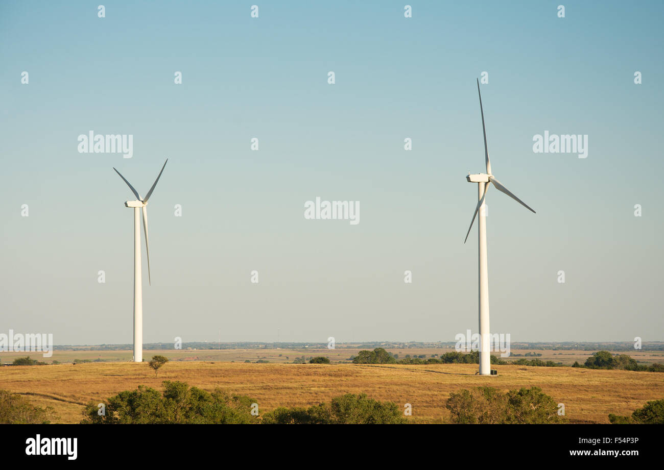 Windmills in a rural area, lit by late afternoon sun Stock Photo