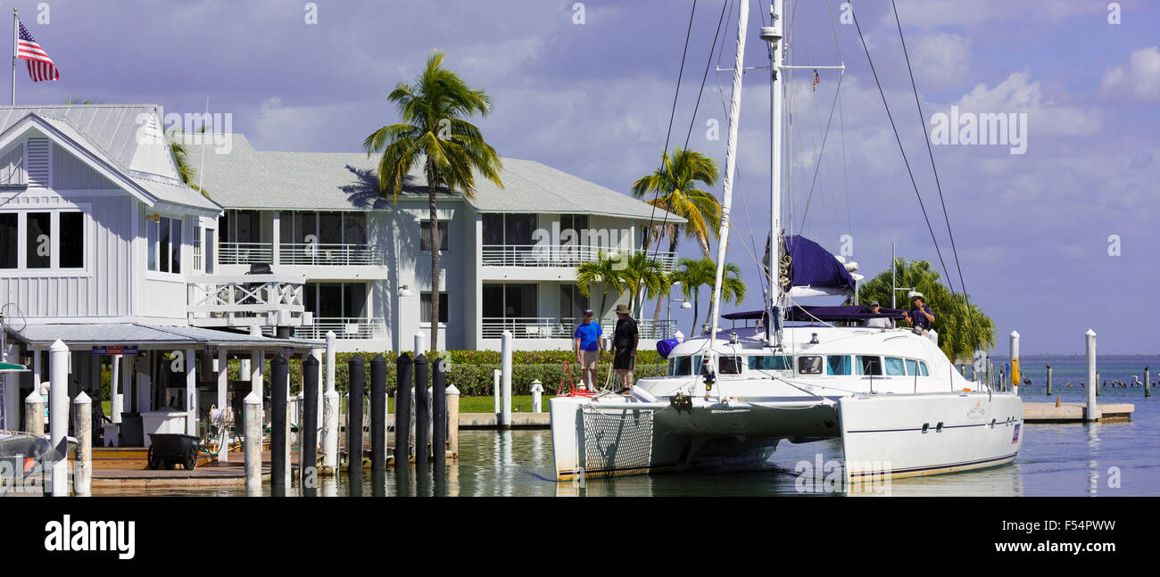 Vacationers sailing luxury catamaran yacht into port at upmarket South Seas Island Resort, Captiva Island in Florida, USA Stock Photo