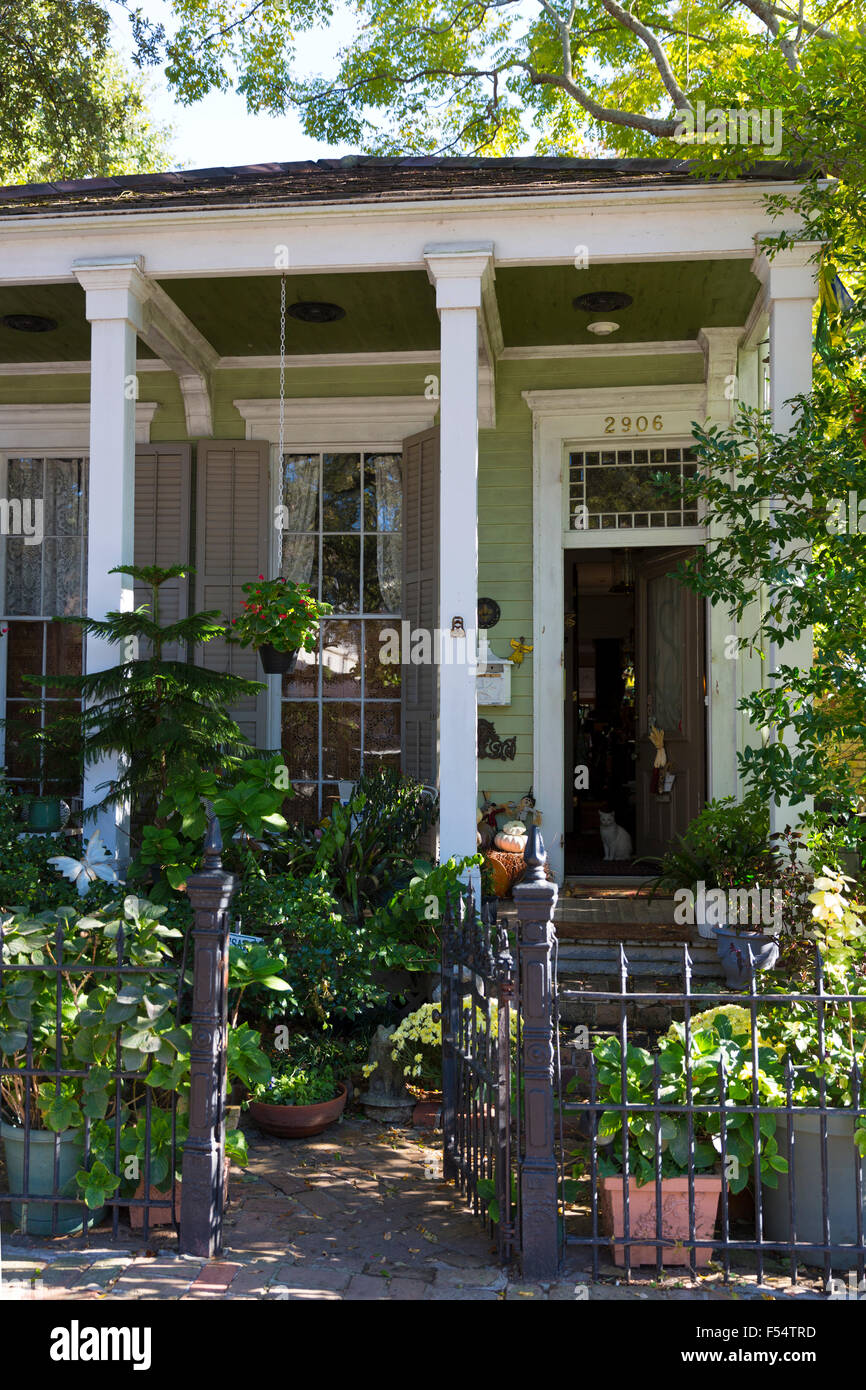 Traditional clapboard cottage house with columns in the Garden District