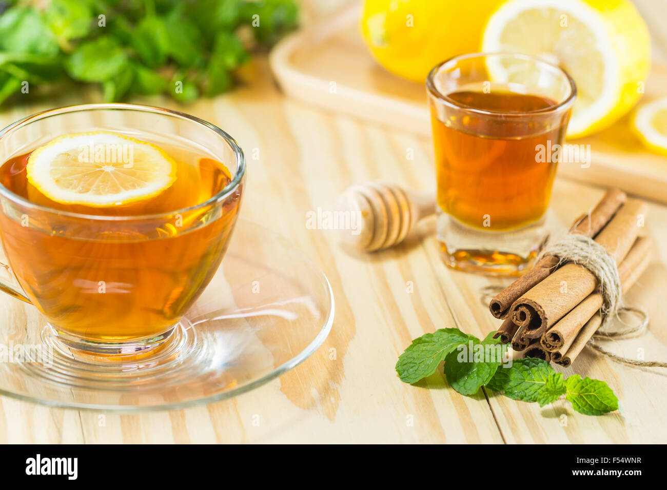 tea with mint honey cinnamon and lemon on wood background,warm toning, selective focus Stock Photo