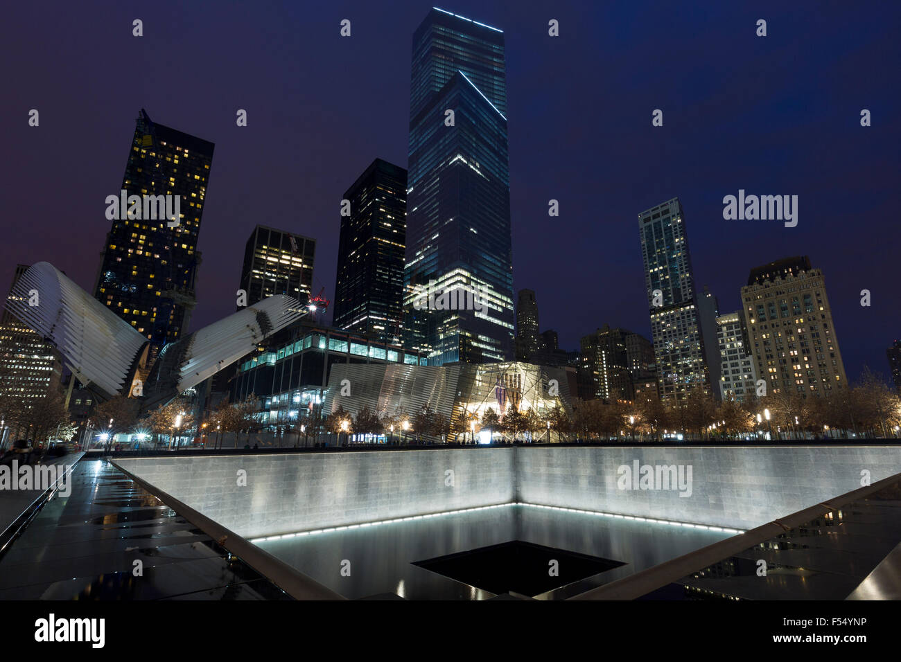 One World Trade Center complex site with museum and illuminated 9/11 Memorial North Tower Pool in New York, USA Stock Photo