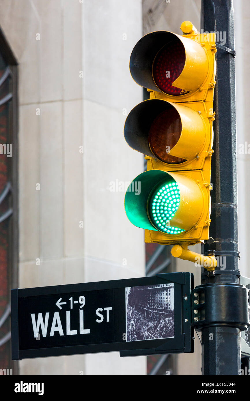 Green traffic light for GO on Wall Street in New York, USA Stock Photo