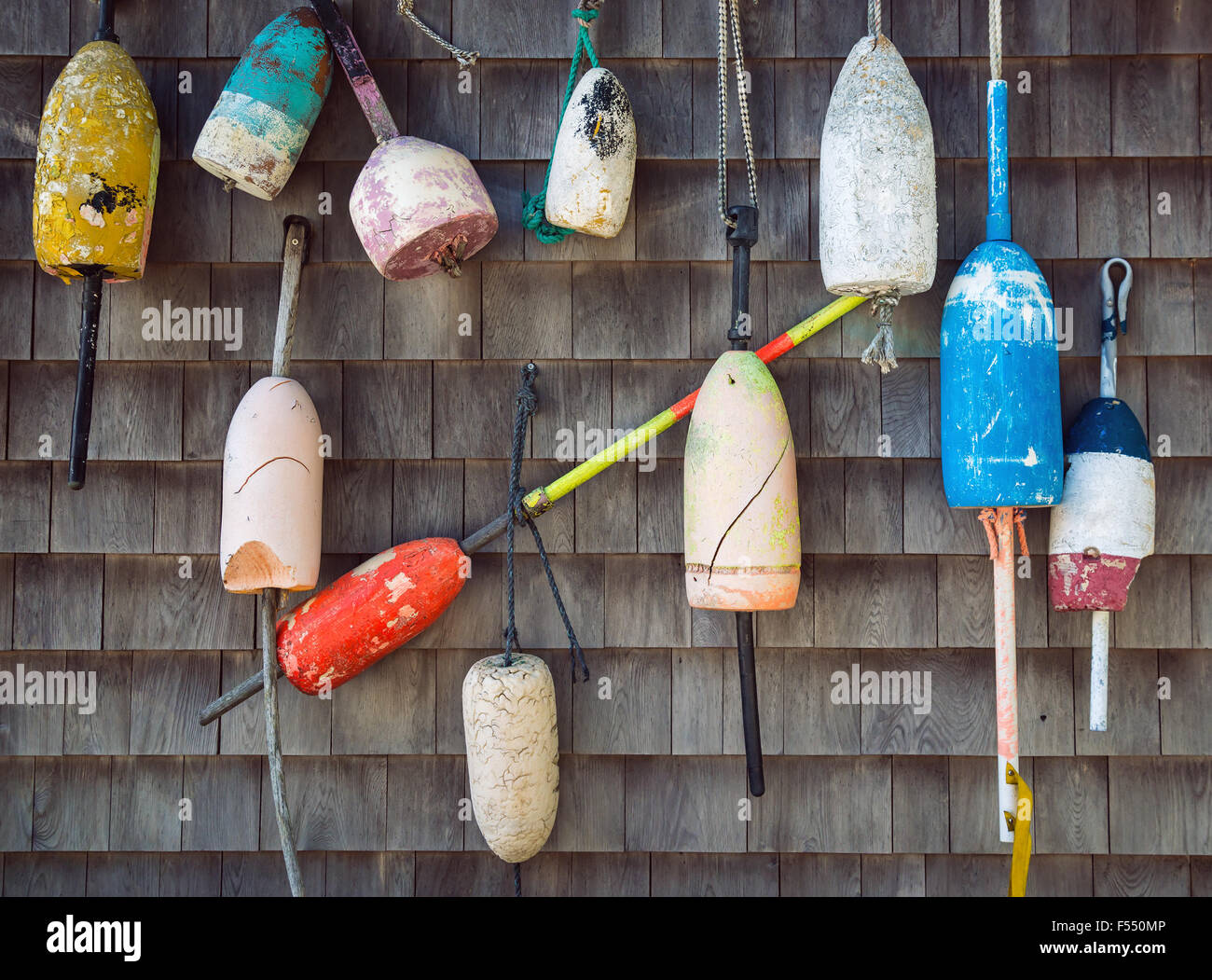 Old weathered lobster buoys hanging on the wall Stock Photo - Alamy