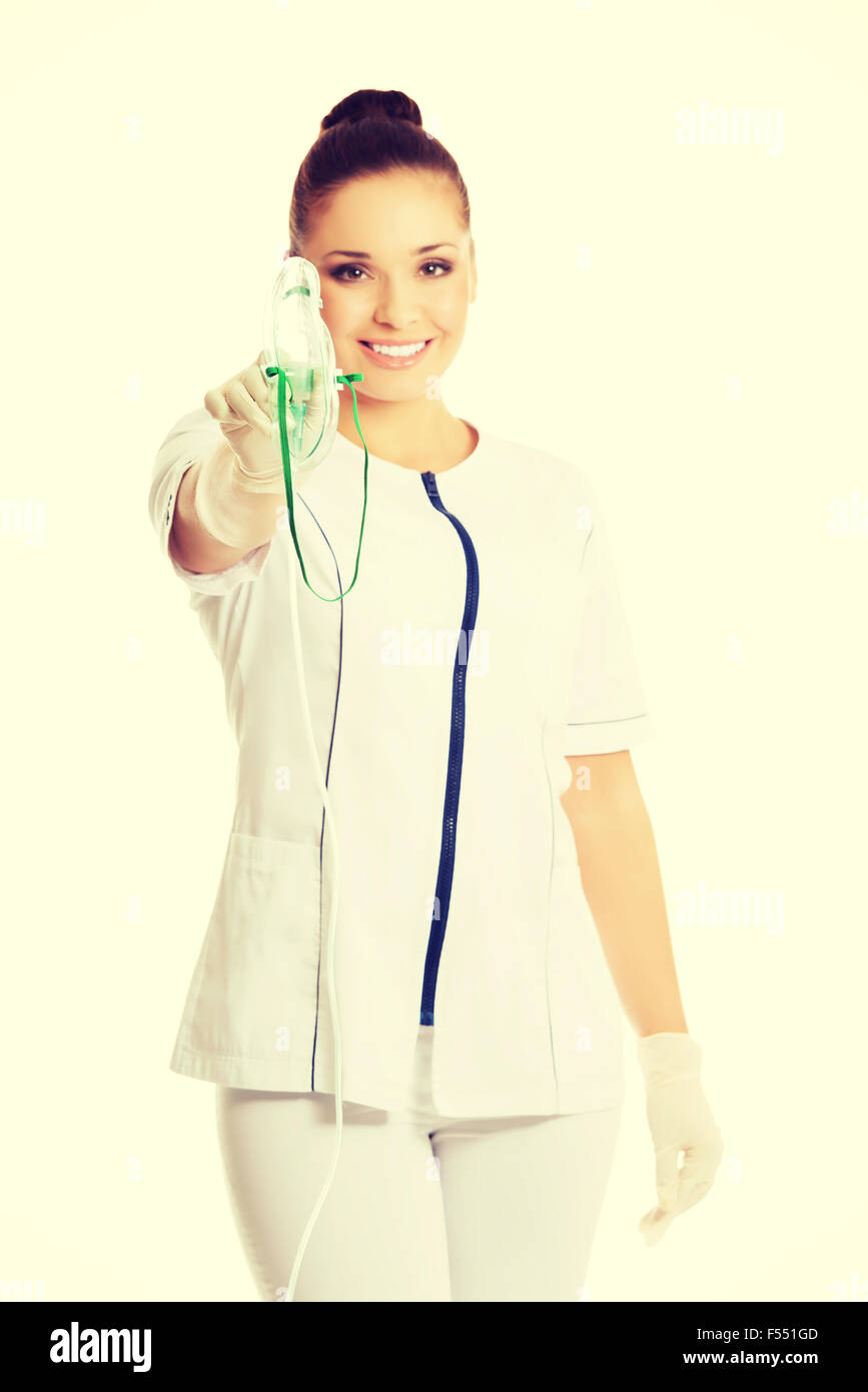 Female doctor holding up oxygen mask Stock Photo - Alamy