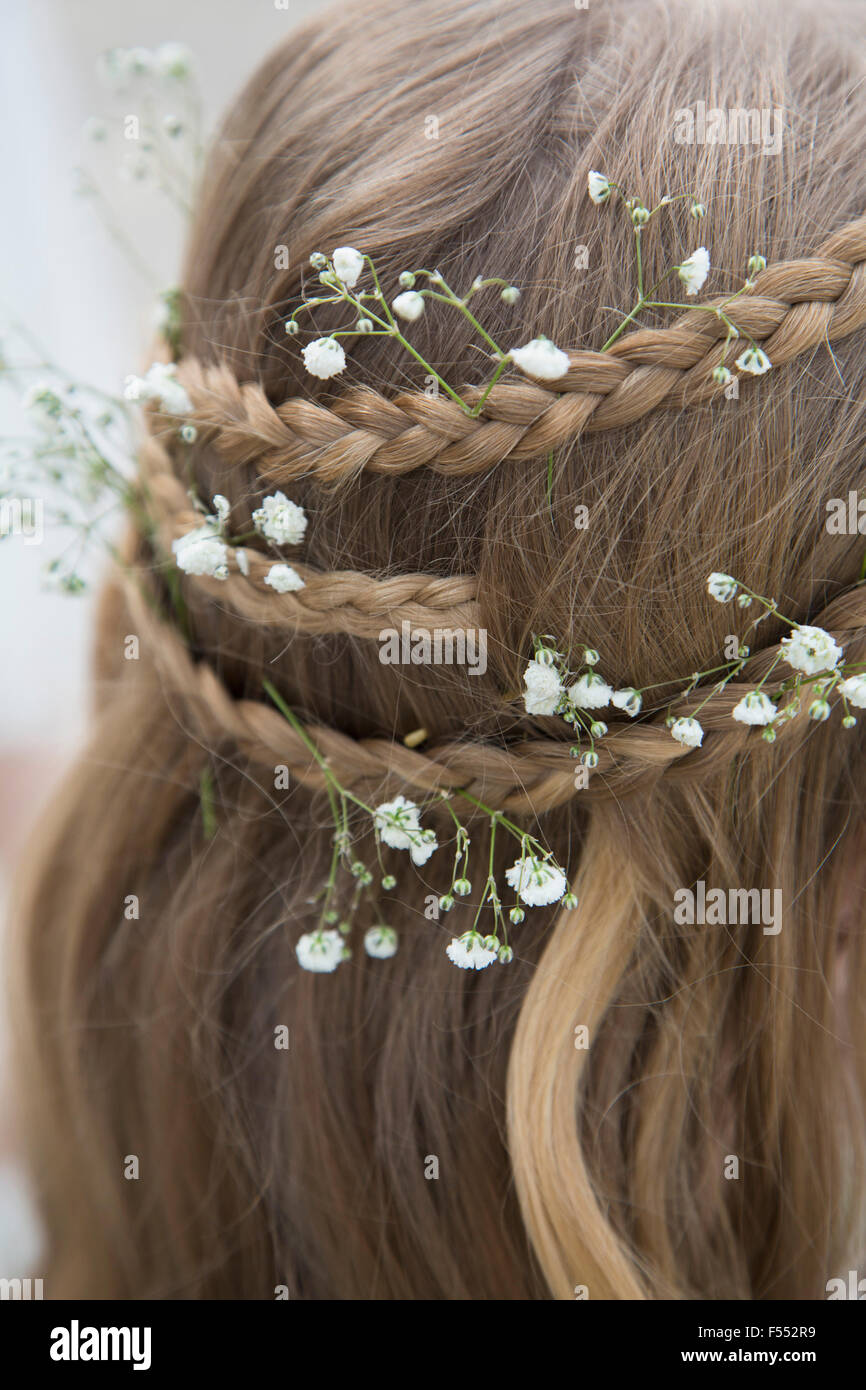 Close-up of flowers in braided hair Stock Photo