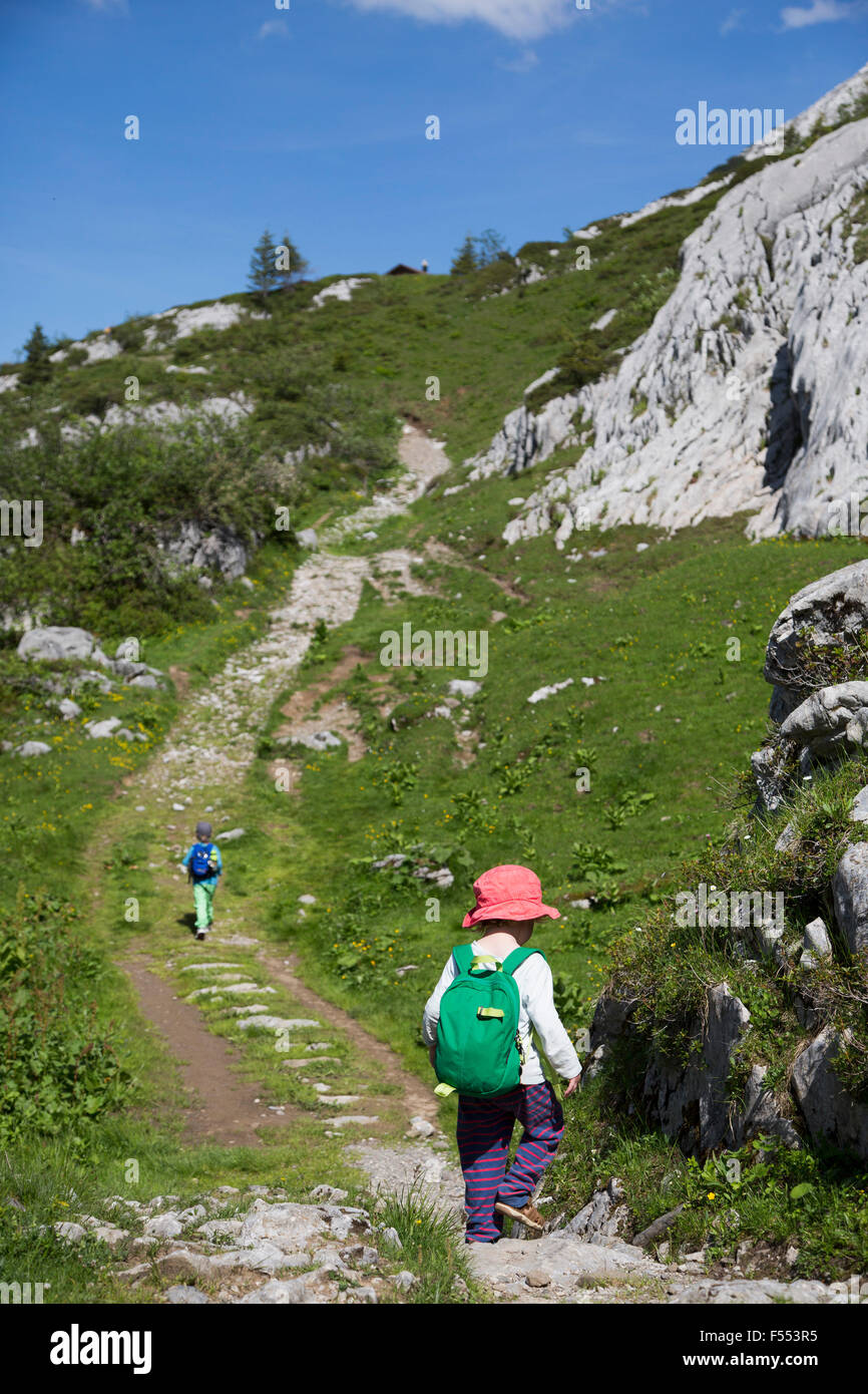 Rear view of boy walking on footpath at Swiss Alps Stock Photo