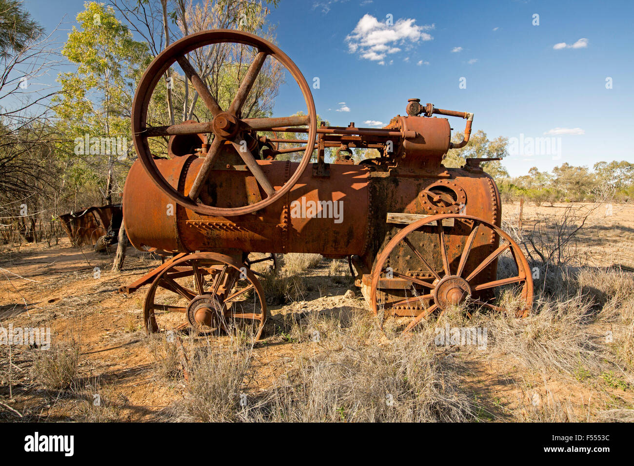 Historic old steam engine, abandoned and rusting in Currawinya National Park, outback Australia under blue sky Stock Photo