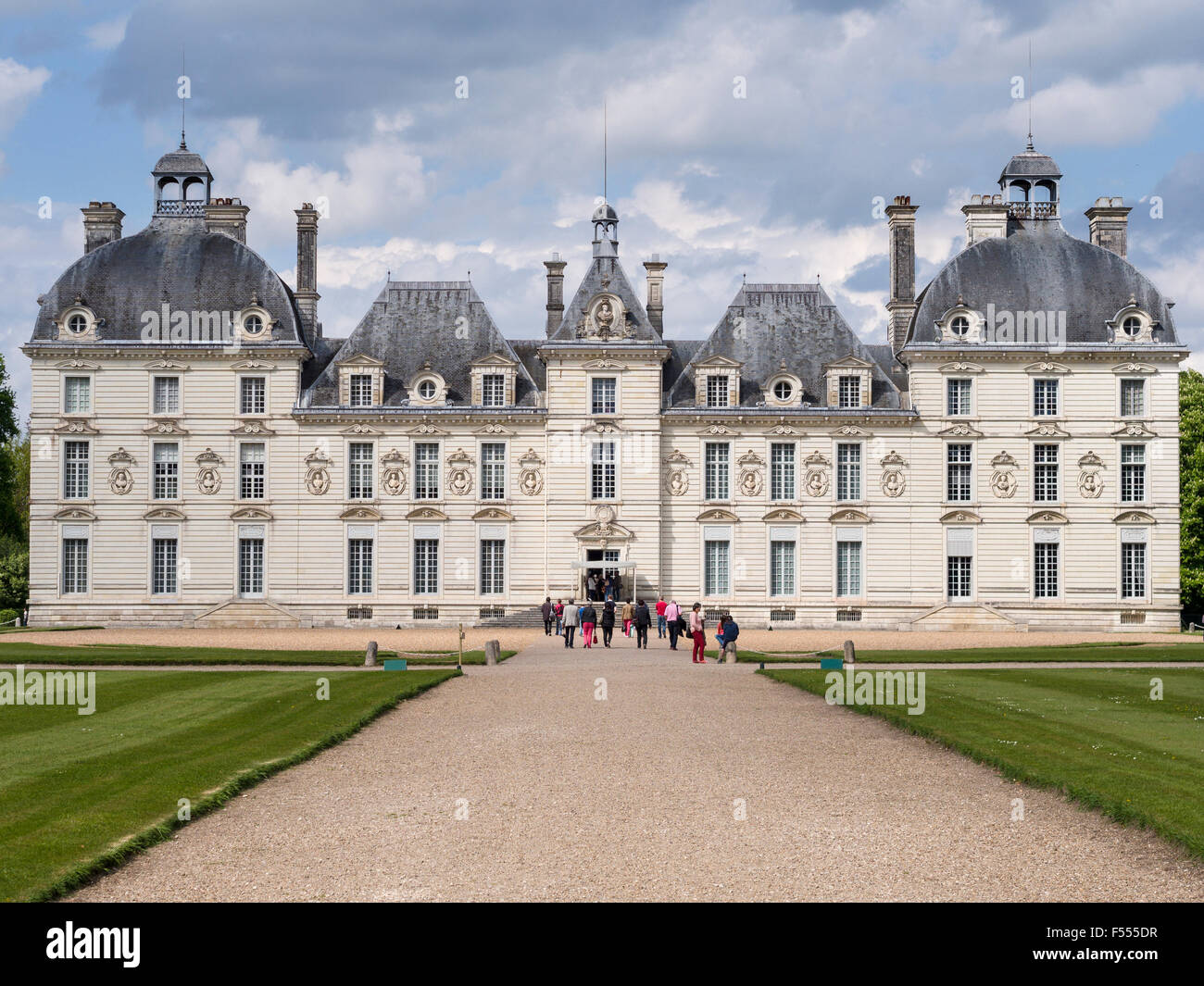 The Front Facade of Cheverny from the grounds. A group of tourists approach the front door to get a tour of the famous Chateau. Stock Photo