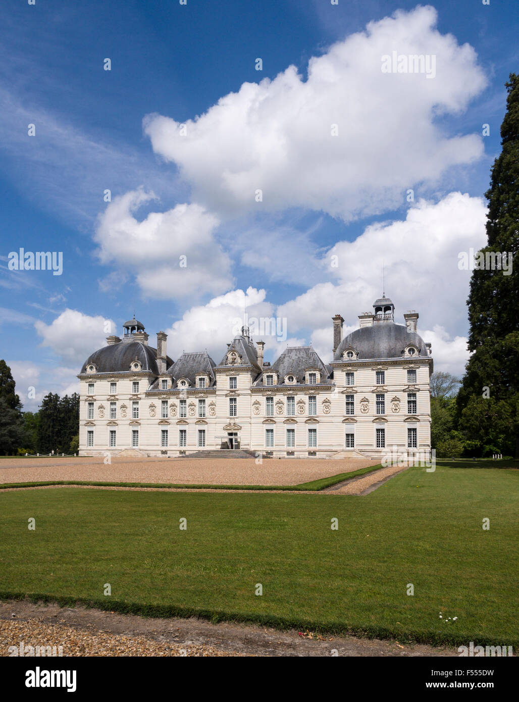 The Front Facade of Cheverny from the grounds. Large billowing clouds dominate the blue sky behind the famouse Chateau. Cheverny Stock Photo
