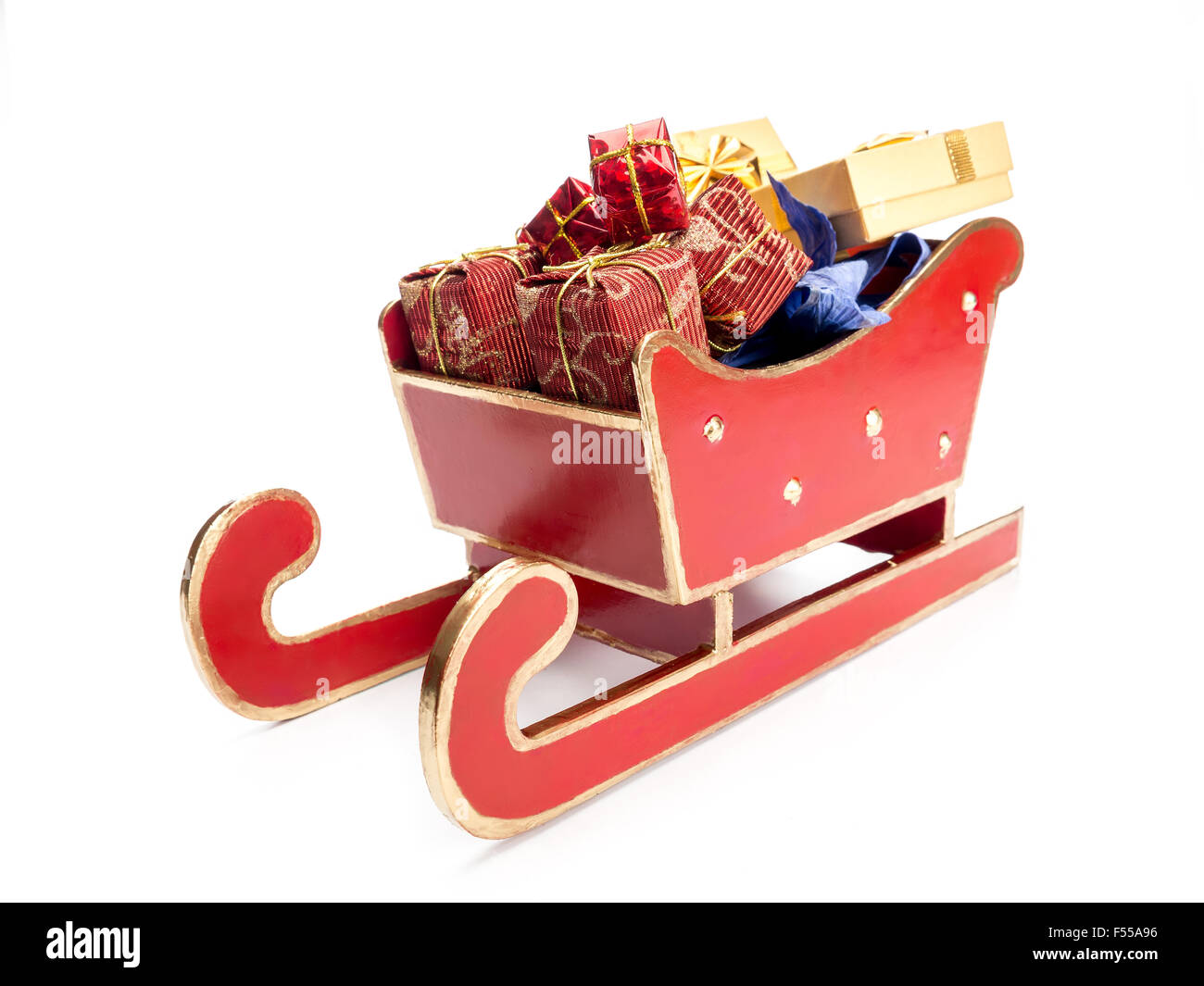 Red sleigh full of christmas presents over white background Stock Photo