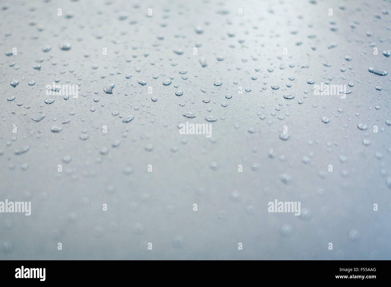 Close-up of water drops on a gray surface Stock Photo