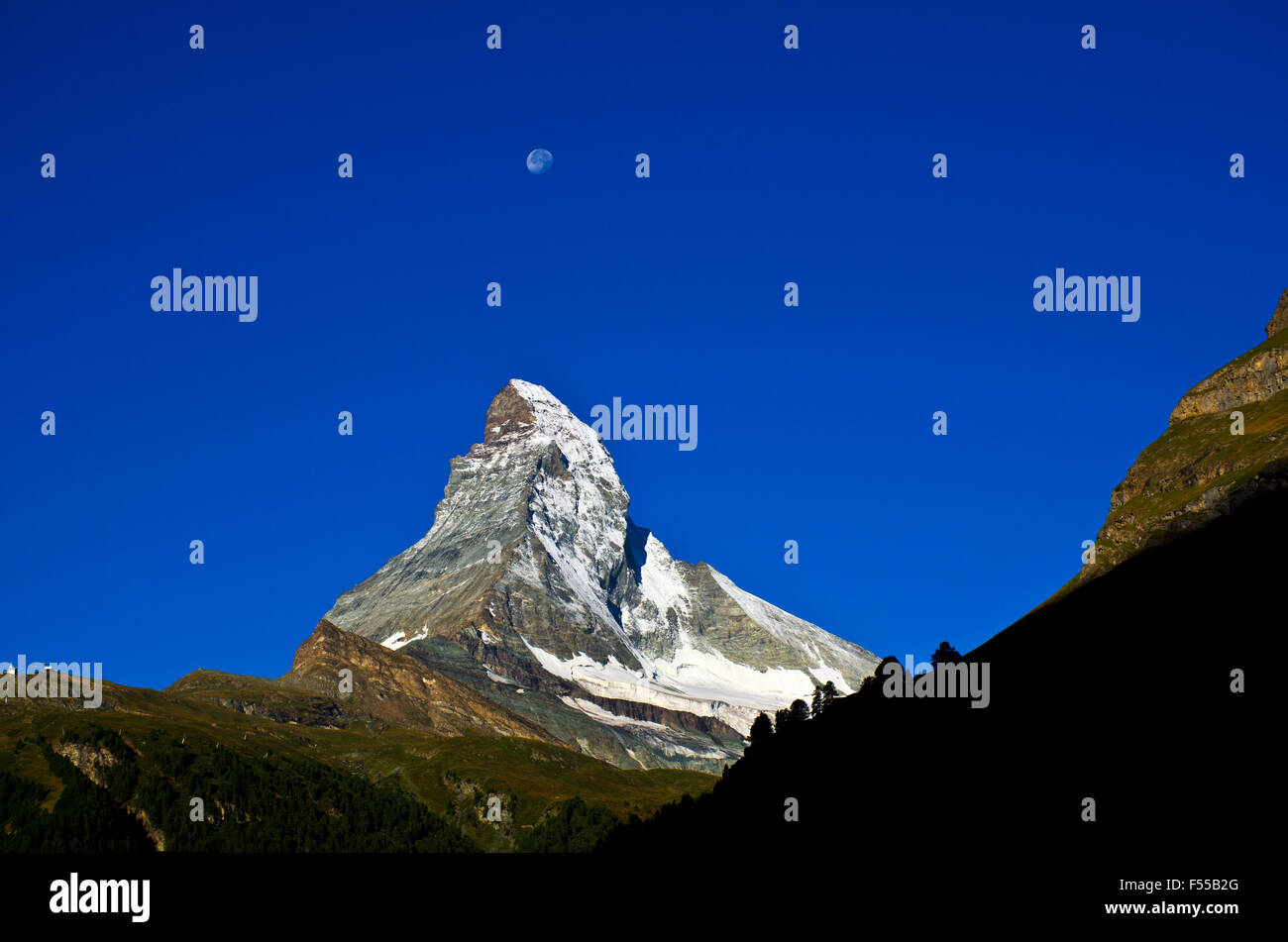 Matterhorn and moon at sunrise seen from Zermatt, Swiss alps, Valais, Wallis, Switzerland Stock Photo