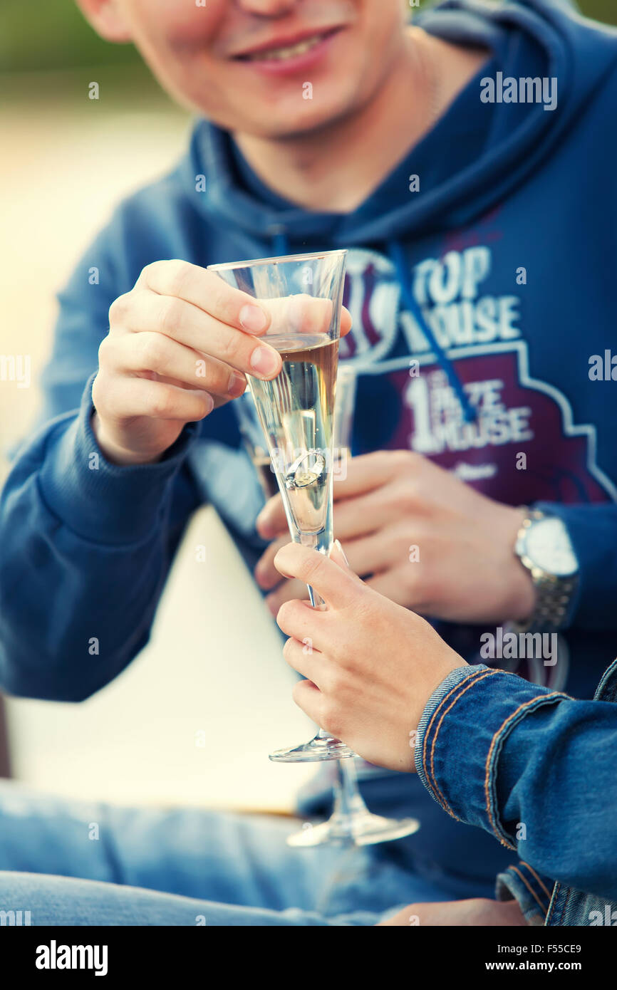 man makes a proposal to the girl and gives her a ring in a glass of champagne Stock Photo