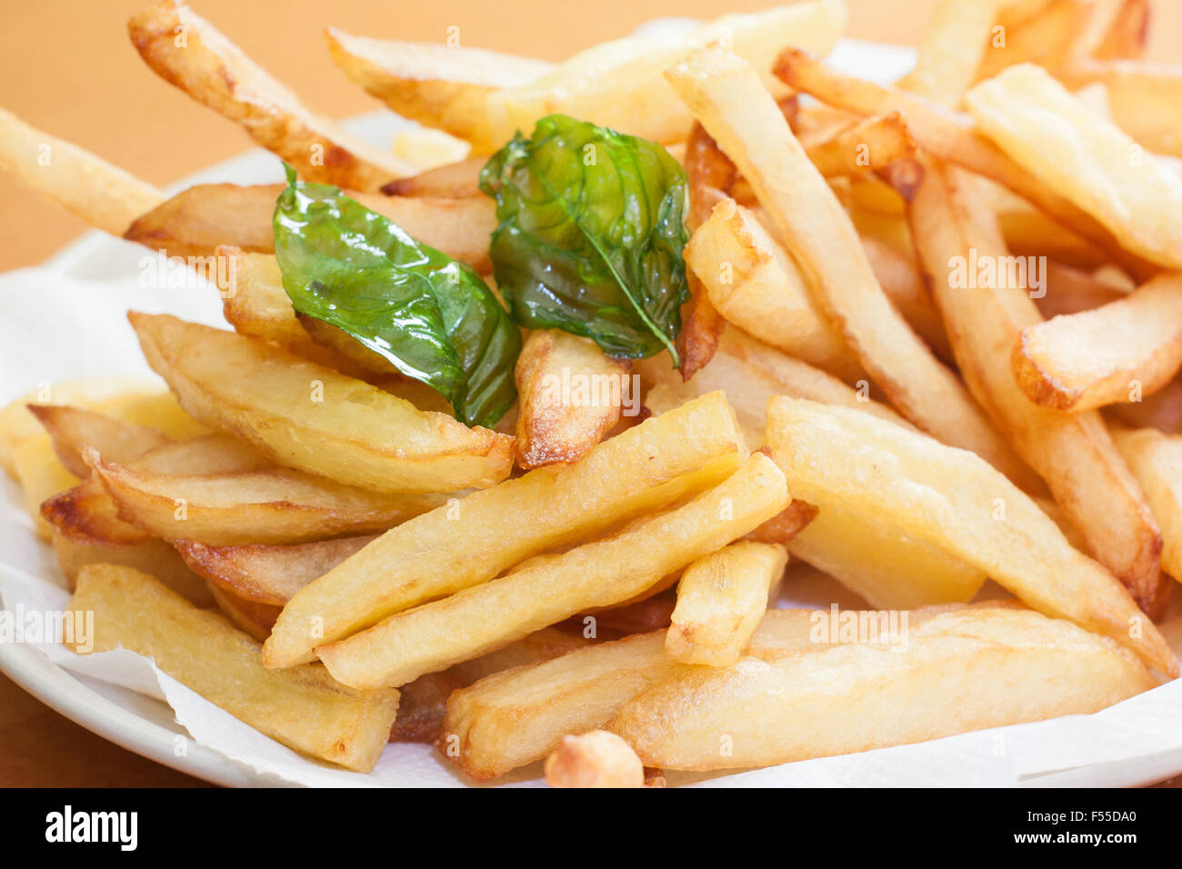 french fries on plate with deep fried basil leave Stock Photo Alamy