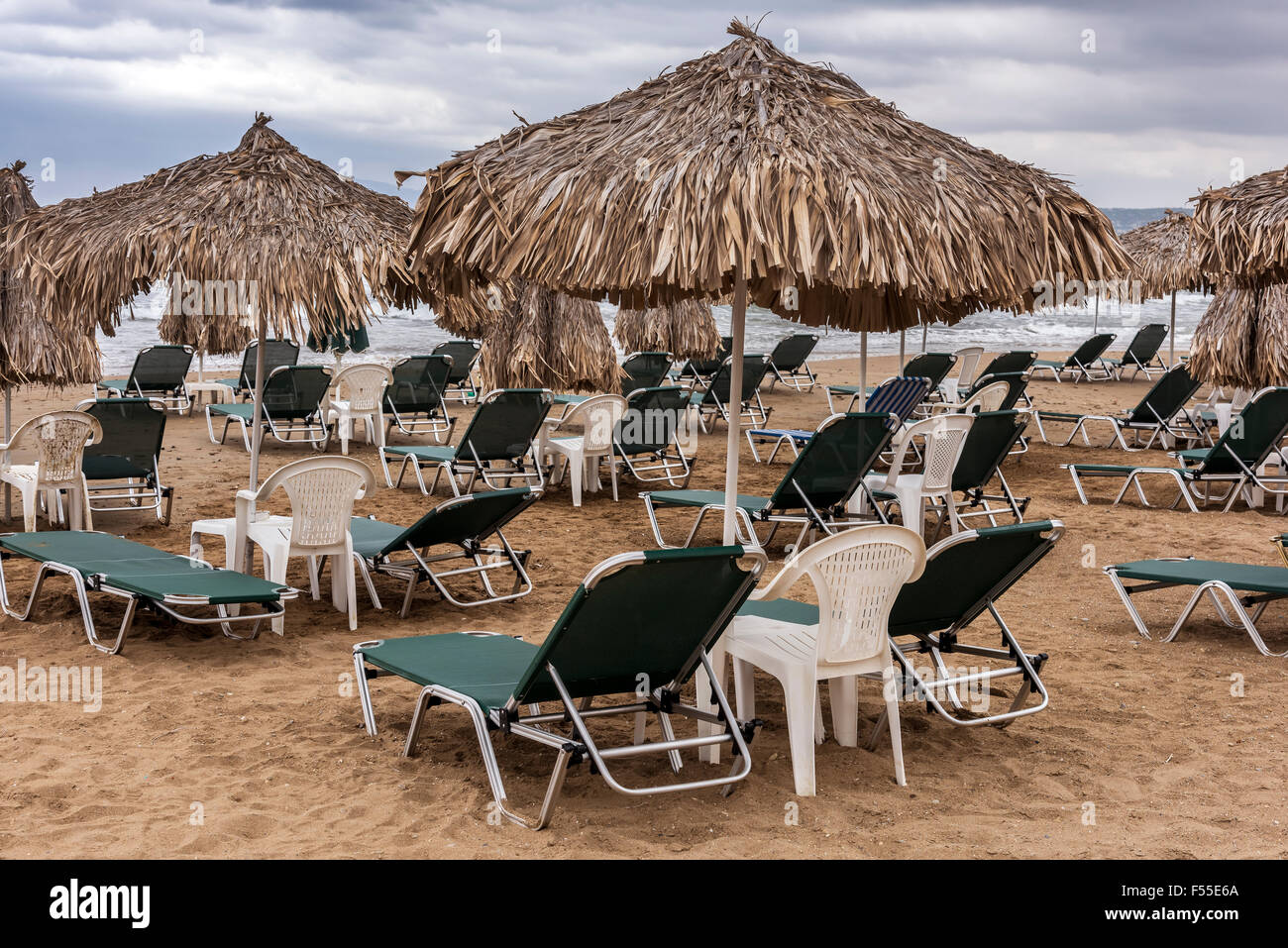 Empty sun beds on Agia Marina Beach, Crete. Stock Photo