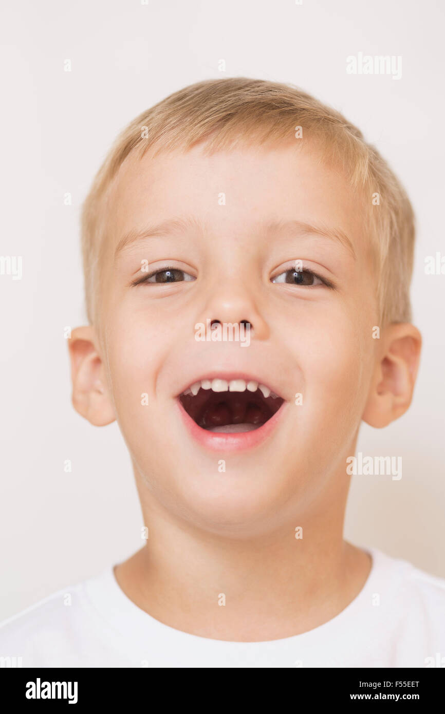 Portrait of happy boy against white background Stock Photo