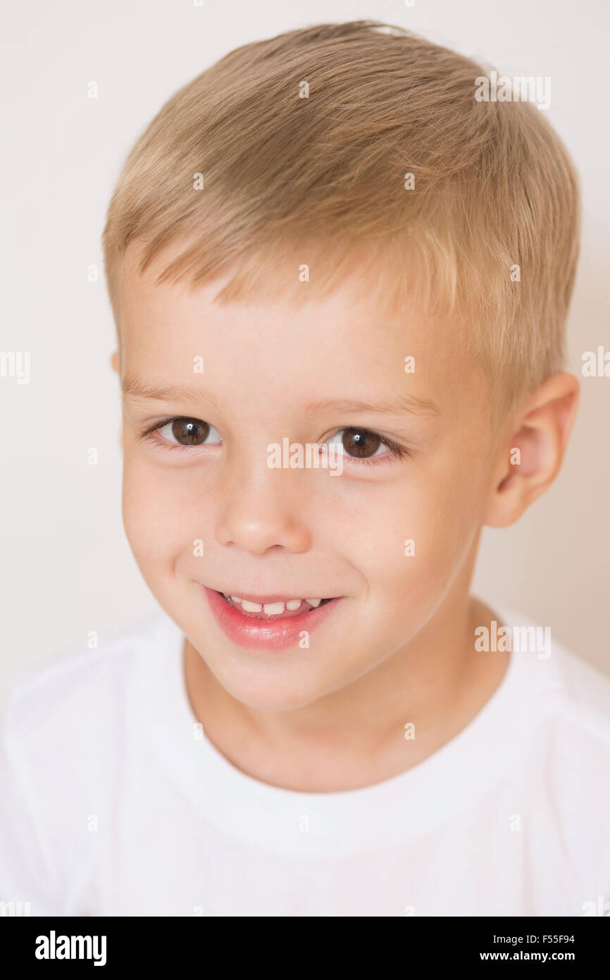 Portrait of smiling boy against white background Stock Photo
