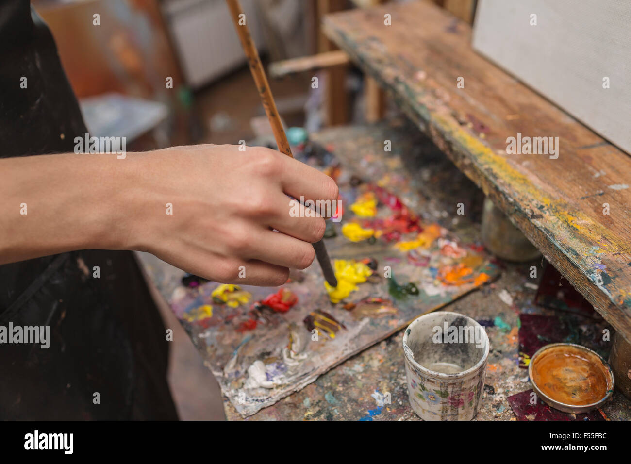 High angle view of artist mixing paint in palette at studio Stock Photo