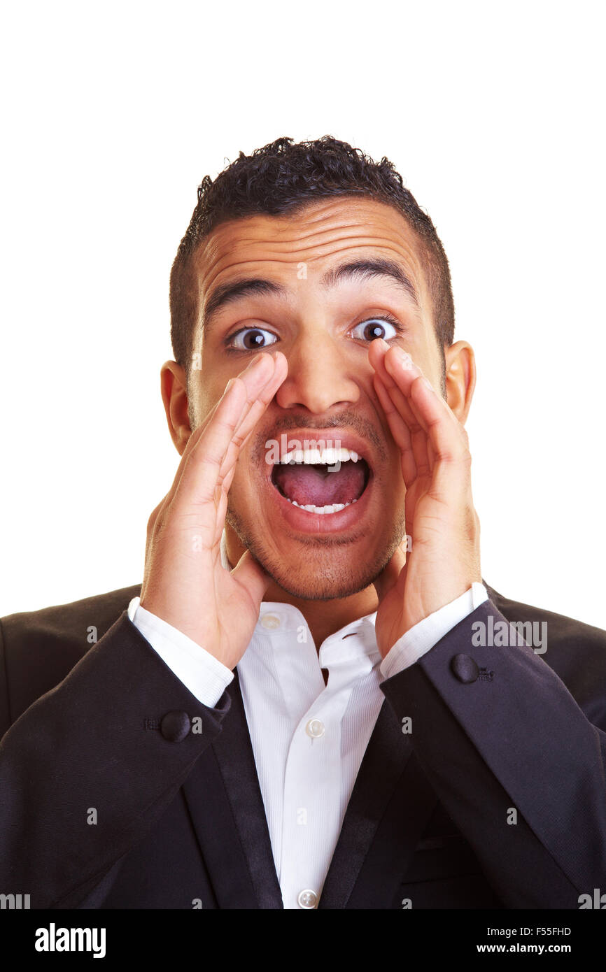 Young manager screaming with hands on his mouth Stock Photo