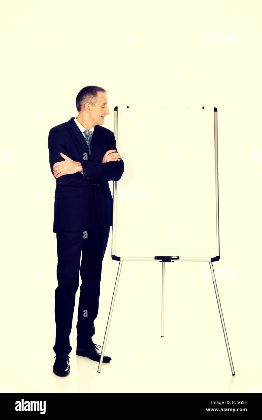 Male executive standing near flip chart Stock Photo