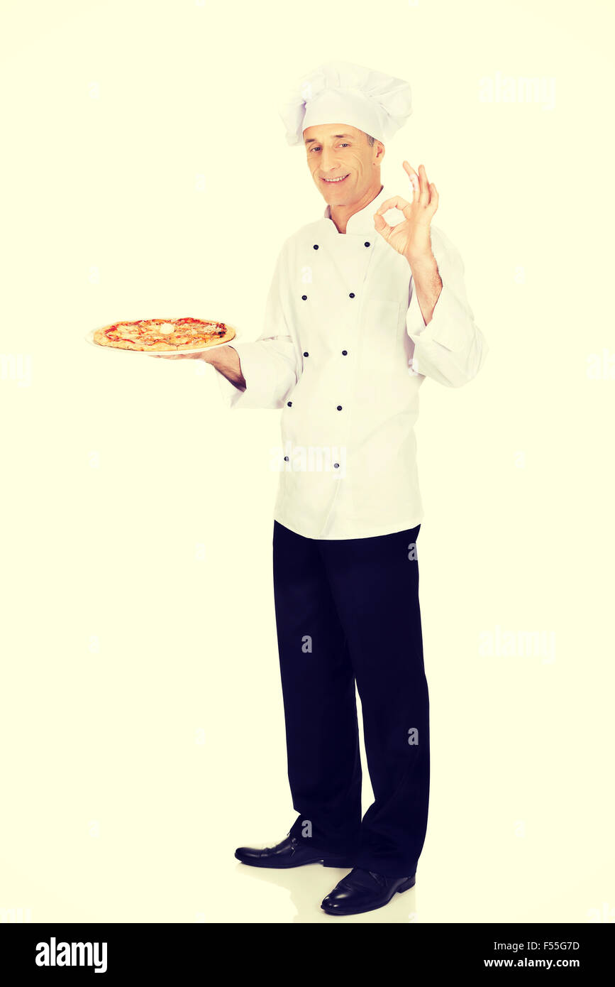 Chef baker with italian pizza showing perfect sign Stock Photo Alamy