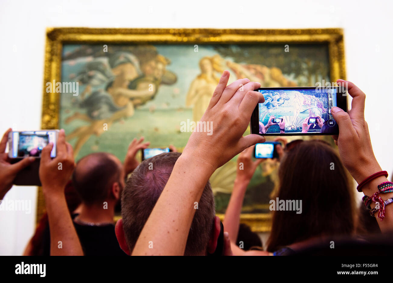 Italy, Florence, tourists taking pictures of 'The Birth of Venus' by Sandro Botticelli in Galleria degli Uffizi Stock Photo