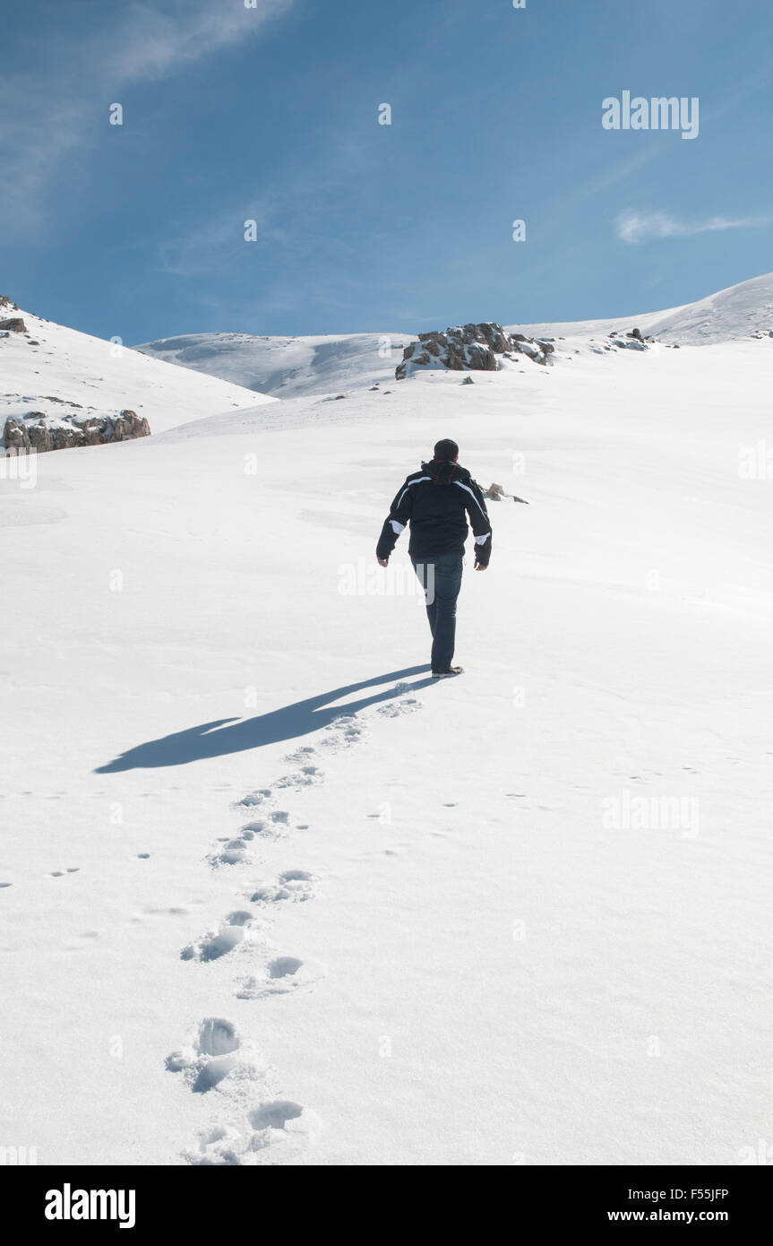 Man walking on the snow Faraya Kesrwan Lebanon Middle East Stock Photo