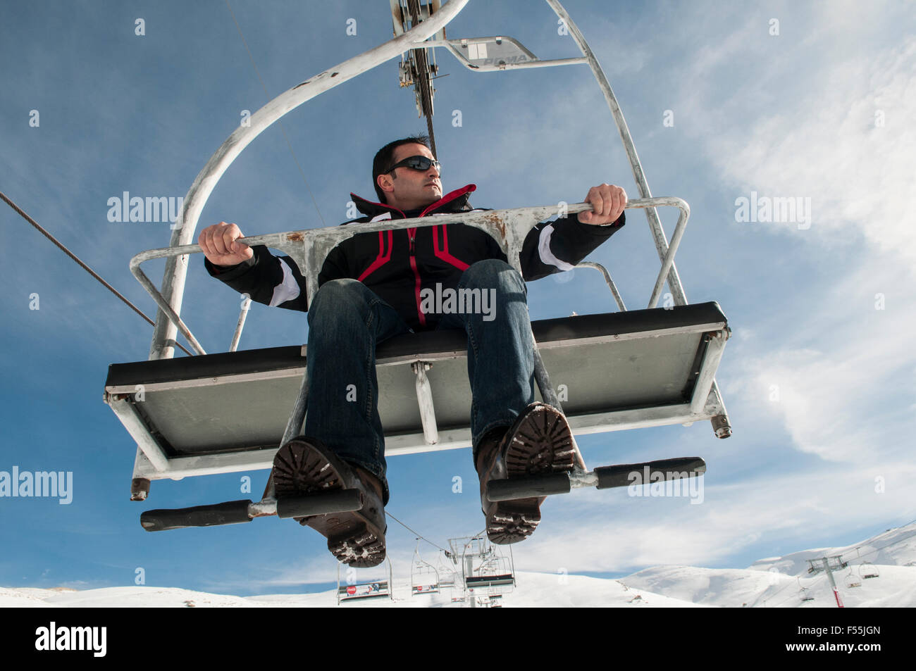 Man on a cable cart at Faraya skiing resort Kesrwan district Lebanon Stock Photo