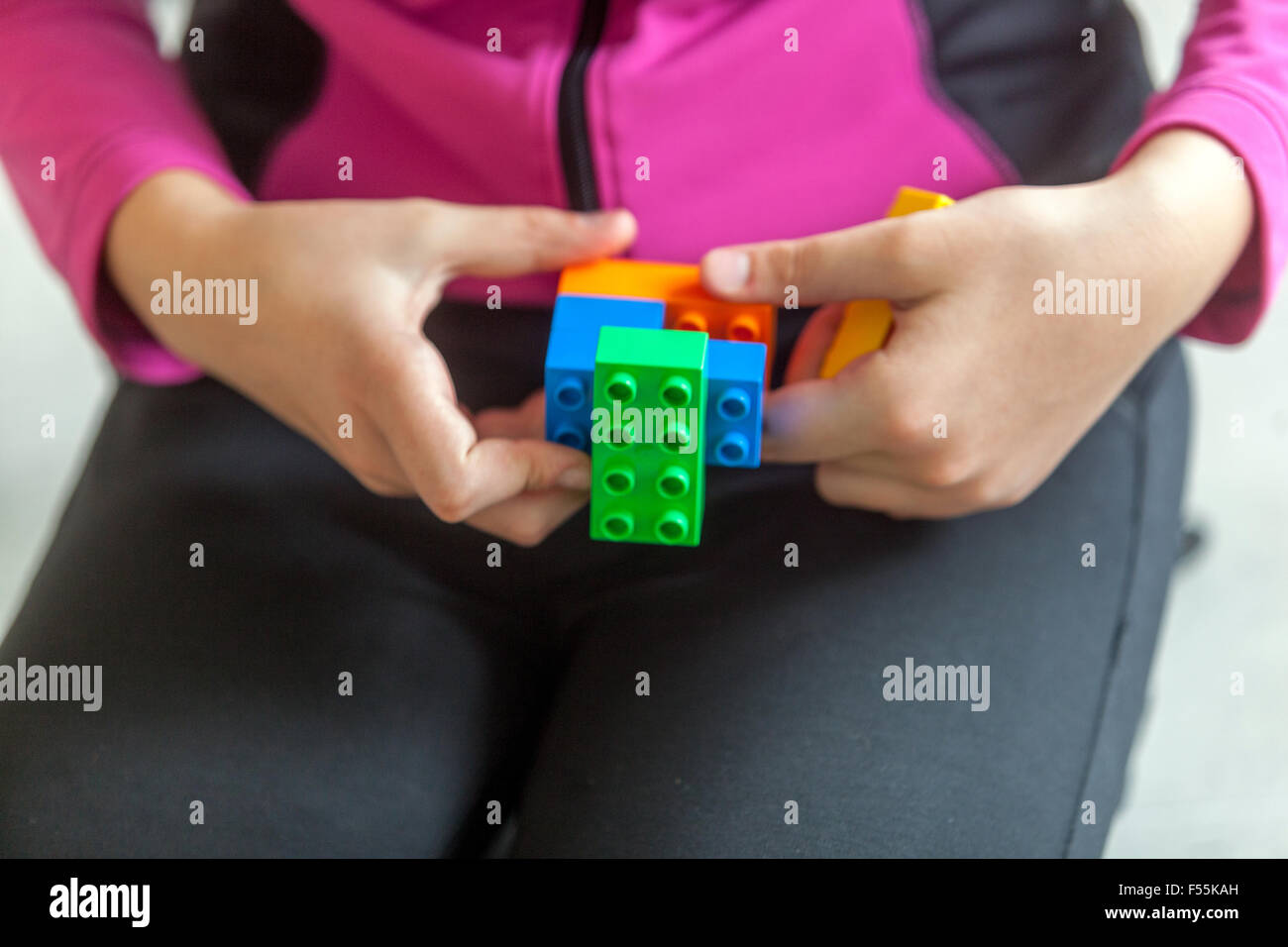 Plastic cubes in the hands of a child's game that develops creativity and imagination Stock Photo