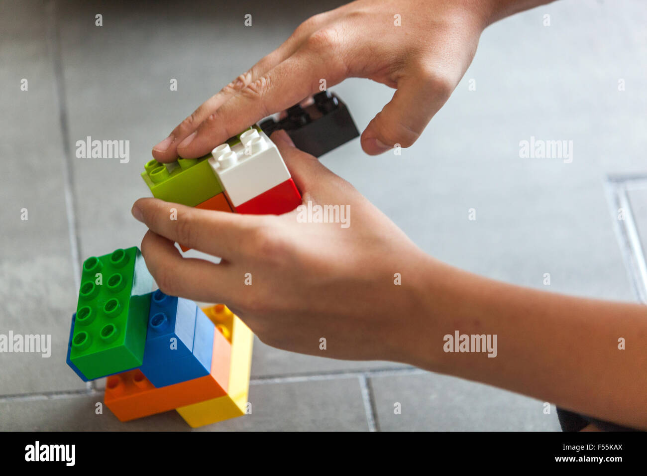 Plastic cubes in the hands of a child's game that develops creativity and imagination Stock Photo