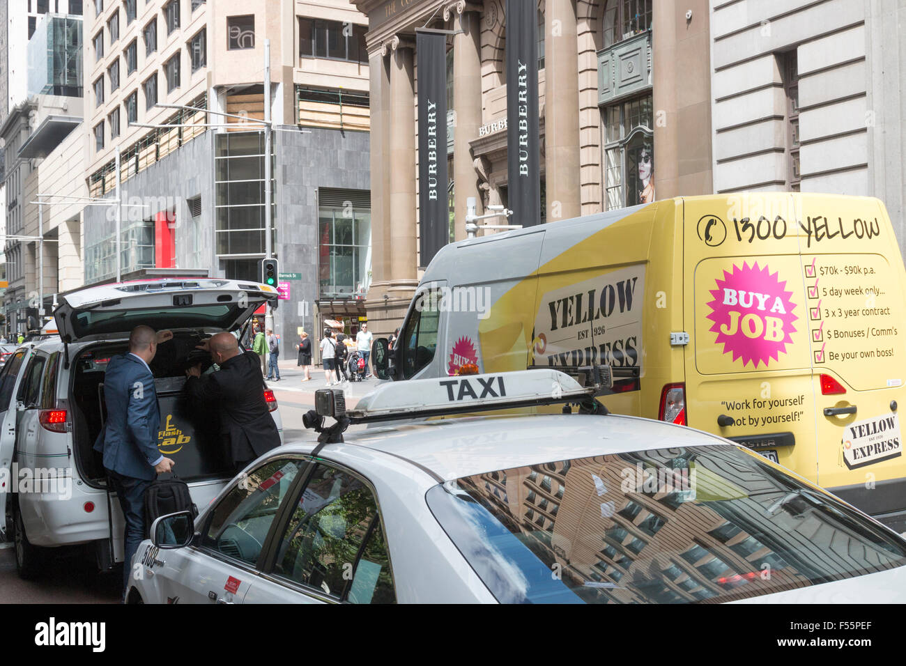 australian taxi in george street Sydney parked behind another with guests exiting the vehicle,Sydney Stock Photo
