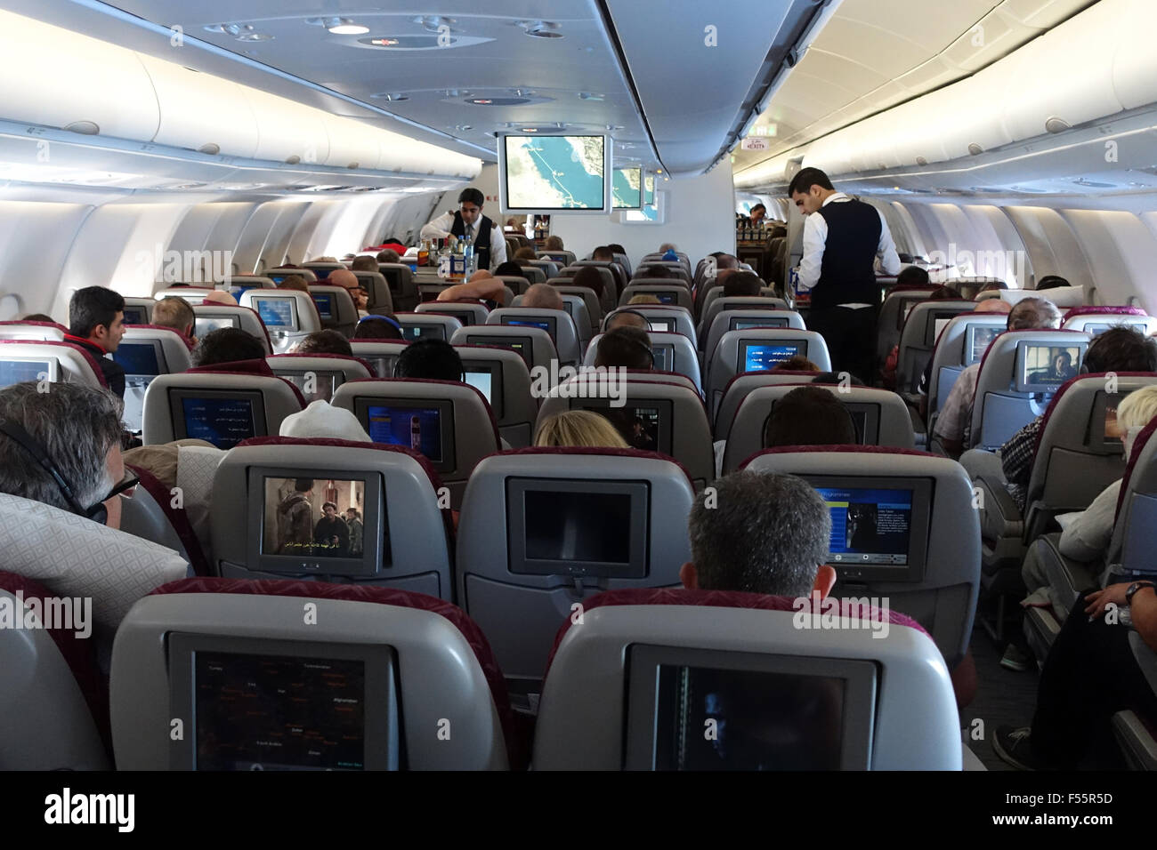 07.03.2015, Doha, Qatar, Qatar - Passengers and flight attendants in an aircraft cabin. 00S150307D627CAROEX.JPG - NOT for SALE in G E R M A N Y, A U S T R I A, S W I T Z E R L A N D [MODEL RELEASE: NO,, PROPERTY RELEASE: NO (c) caro photo agency / Sorge, http://www.caro-images.pl, info@carofoto.pl - In case of using the picture for non-journalistic purposes, please contact the agency - the picture is subject to royalty!] Stock Photo
