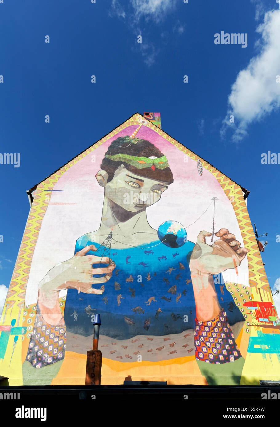 Surreal figure holding globe, pylon and rig, mural by Brazilian artists' collective ACIDUM, Urban Art Festival City Leaks 2015 Stock Photo