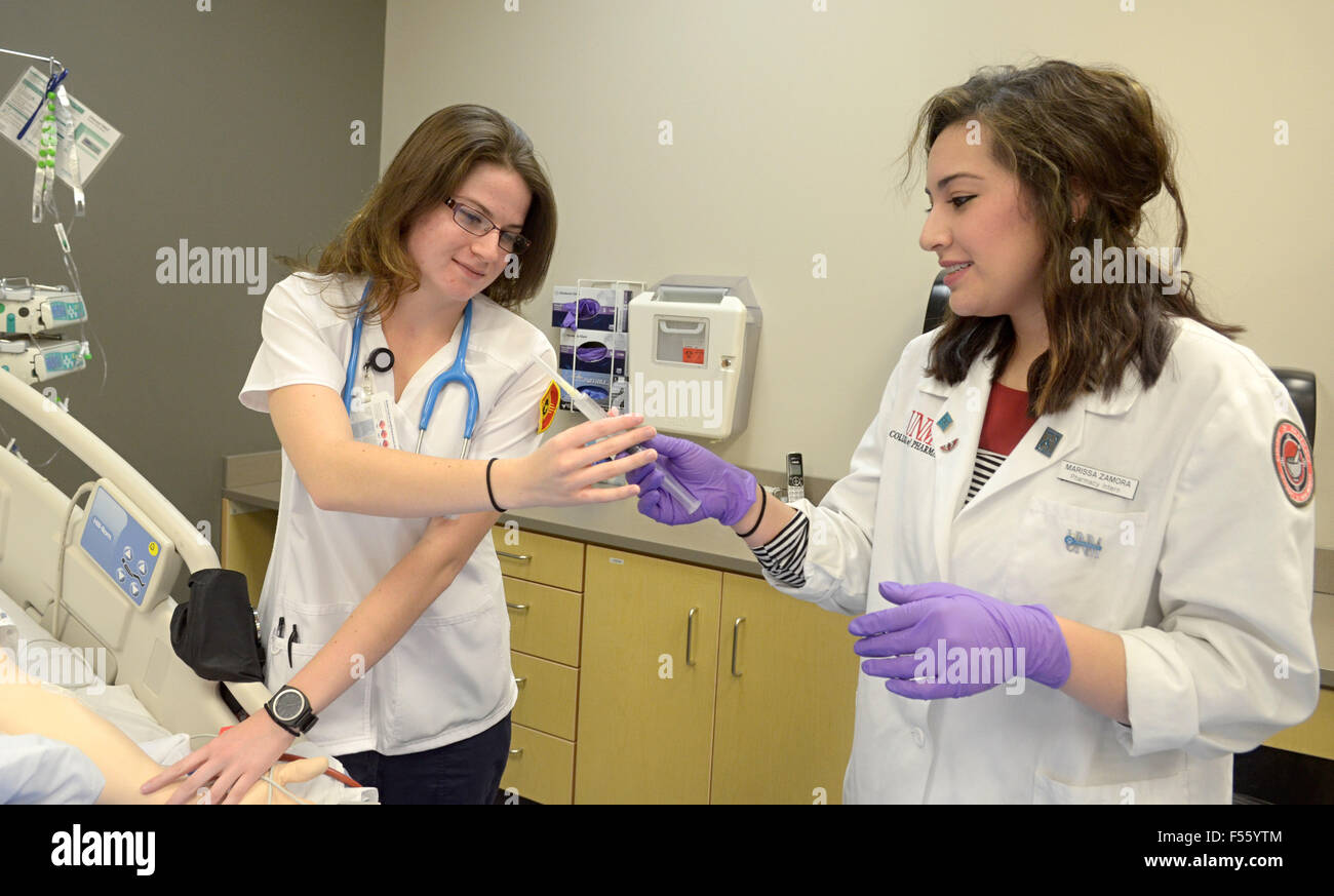 Oct. 26, 2015 - Albuquerque, NM, U.S. - 10272015---University of New Mexico college of Nursing student Claire Lael (CQ) left, receives a syringe prepared by College of Pharmacy student Marissa Zamora (CQ) while working together at the Interprofessional Healthcare Simulation Center (IHSC) at the Domenici Center for Health Sciences Education on the campus of UNM, photographed on Tuesday October 27, 2015. (Credit Image: © Dean Hanson/Albuquerque Journal/Albuquerque Journal via ZUMA Wire) Stock Photo