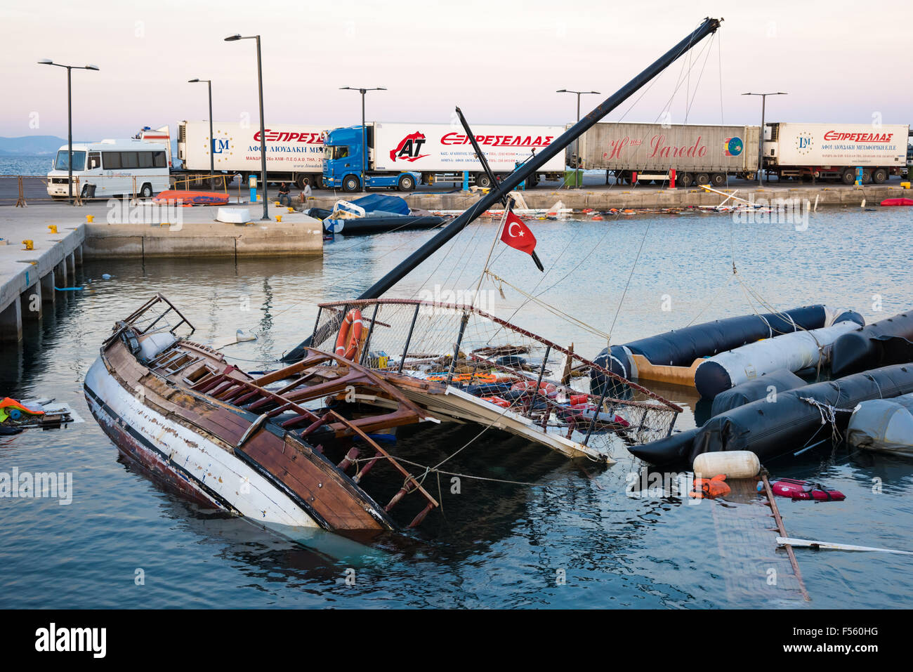 Half sunken ship and damaged boats on October 14, 2015 in the harbor of Kos island, Greece. Stock Photo