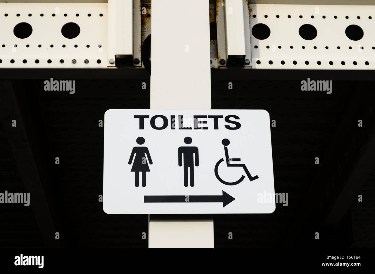 A sign pointing the way to the toilets. Stock Photo