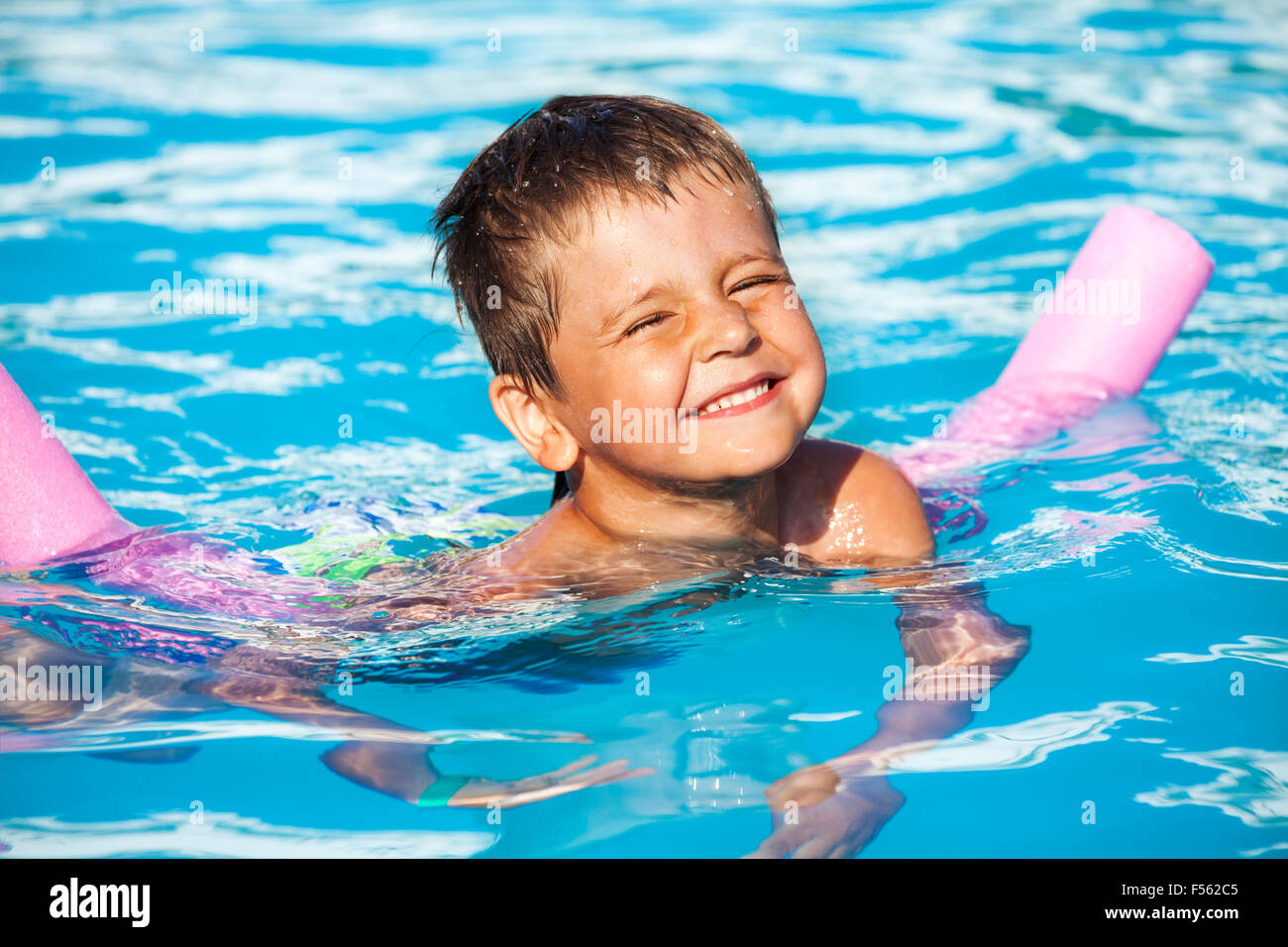 Closeup of boy learning to swim with pool noodle Stock Photo Alamy