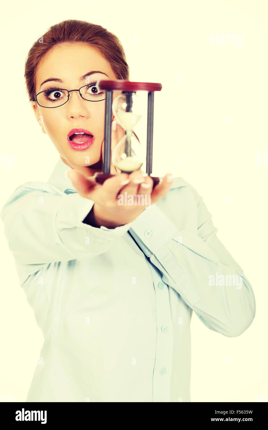 Young shocked business woman with hourglass - time concept Stock Photo ...
