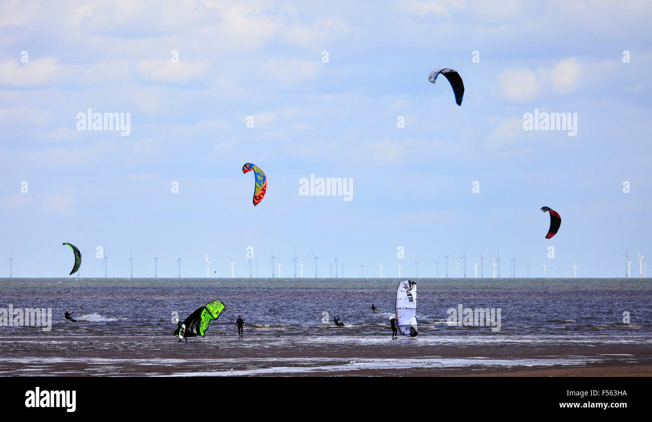 Kite surfers with an offshore wind farm behind at Old Hunstanton, Norfolk, England, UK. Stock Photo