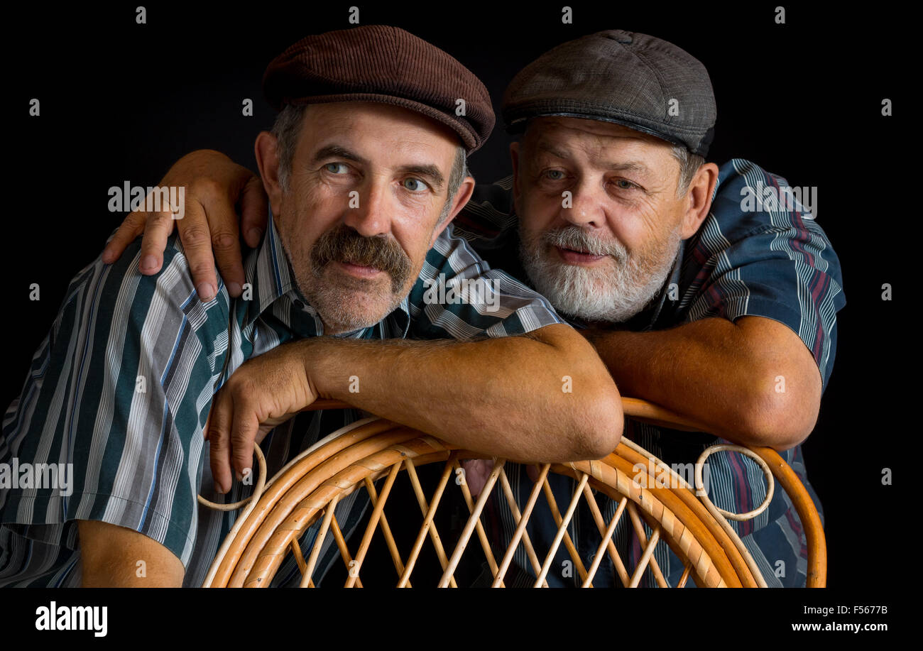 Portrait of two mature Ukrainian peasant in low key. One is moustached, onother one - bearded Stock Photo