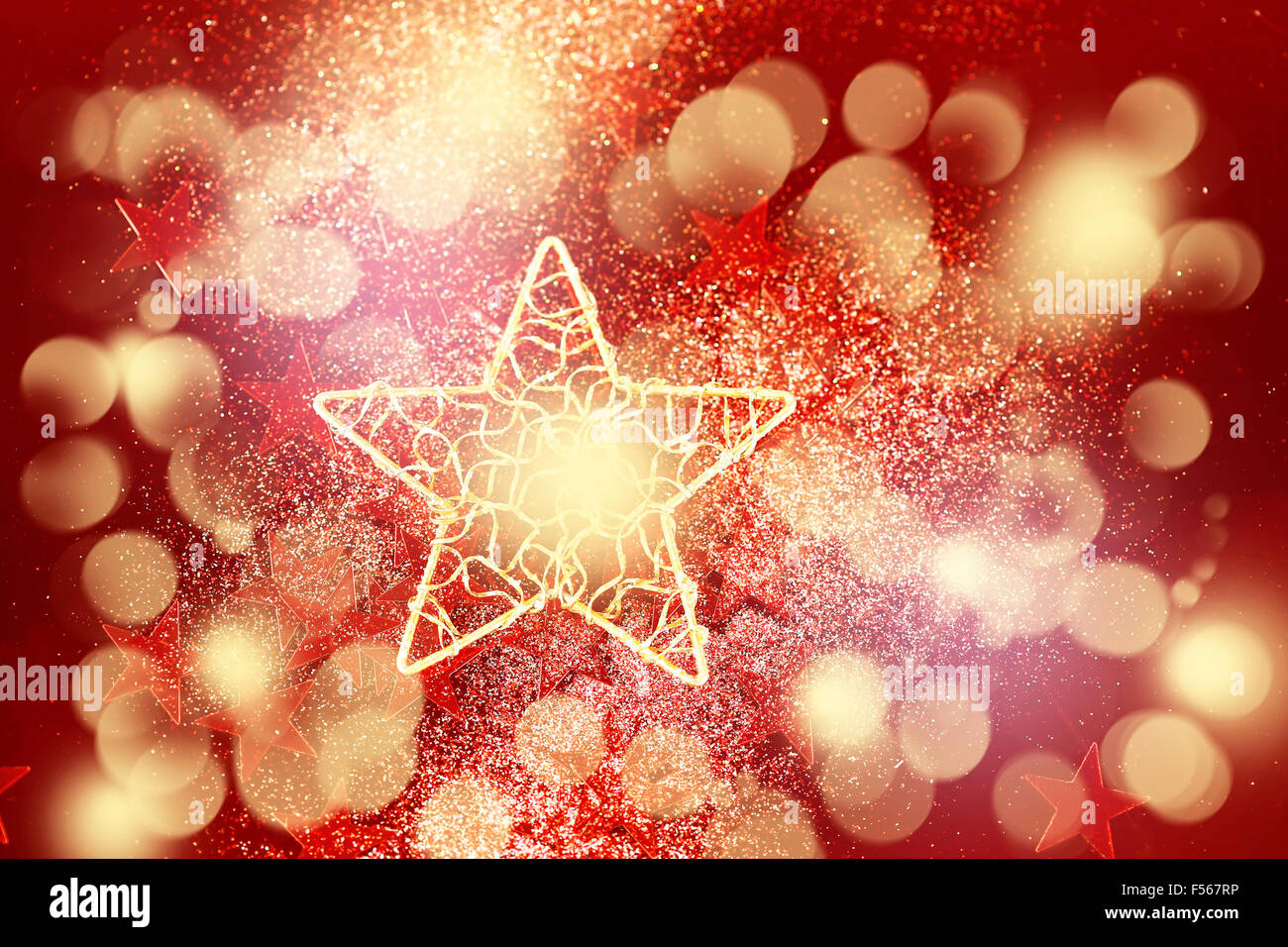 Holiday background with abstract red glitter decoration with big golden