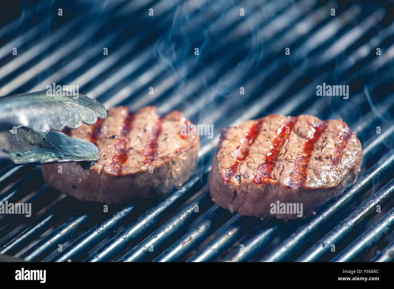Delicious steak on grill Stock Photo