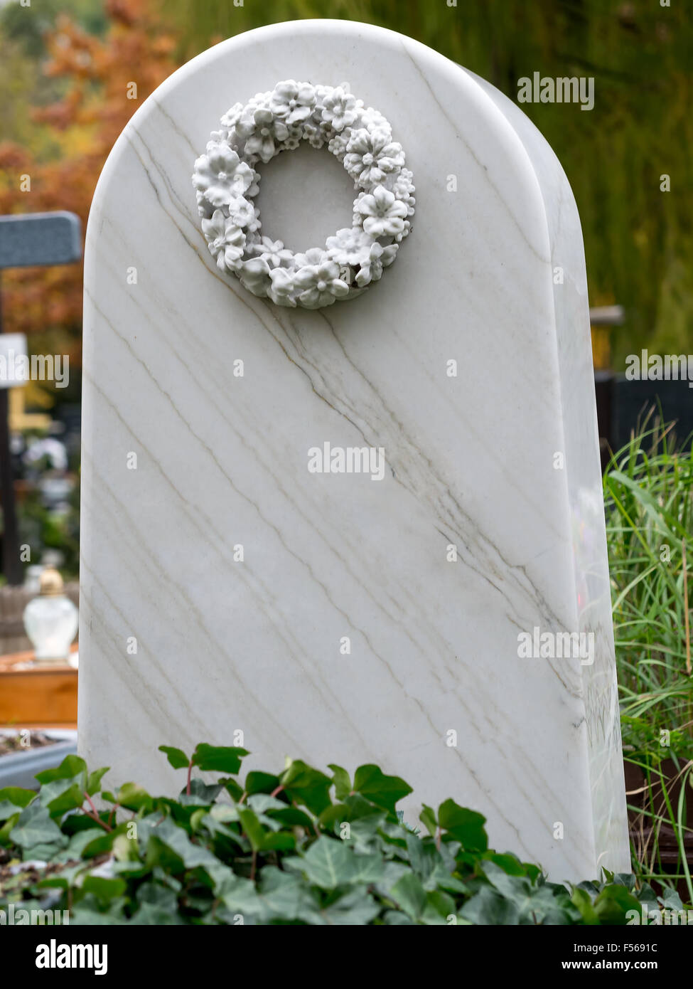 White marble tombstone at the catholic cemetery Stock Photo