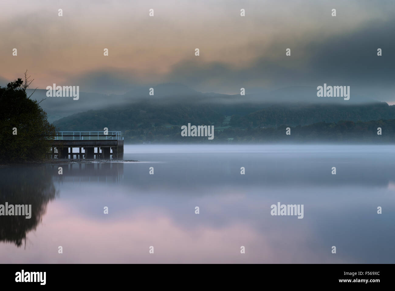 The Pier at dawn during mist on Ullswater Lake,  Howtown, Lake District National Park, Cumbria, England, Uk, Gb. Stock Photo